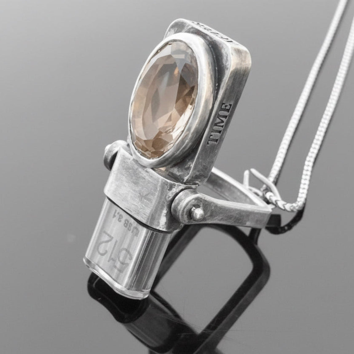 Angled USB Drives Necklace in oxidized sterling silver with champagne citrine displayed on a black reflective surface.