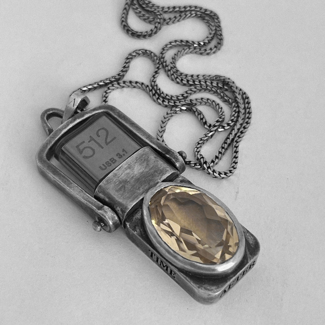 Sterling silver USB Drives Necklace and chain on subtly embossed Ambrosio paper with a faceted champagne citrine.